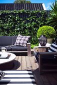 Comfortable garden furniture on wooden terrace in urban surroundings