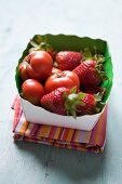 Strawberries and tomatoes in a small box