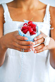 Woman holding cupcake with berries