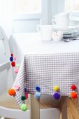 Tablecloth decorated with colourful pompoms