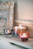 Elegant tealight holders on cabinet