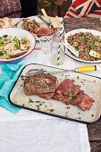 Picnic with beef fillet and quinoa salad with grilled courgette, preserved lemons and asparagus