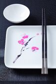 Asian tableware with a flower motif and chopsticks