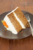 A slice of carrot cake with cream cheese icing (USA)