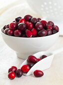 Cranberries in a white bowl and in a shovel
