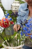 Woman arranging summer bouquet