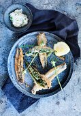 Deep-fried herring with lemon and a herb butter