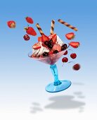 A flying strawberry sundae with flying ingredients