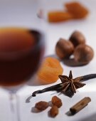 A glass of dessert wine, spices, nuts and dried fruits