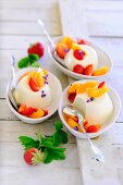 Panna cotta with strawberries, apricots and lavender flowers