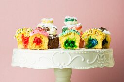 Halbierte, gefüllte Cupcakes auf einem Tortenständer