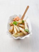 Fried white asparagus with parsley and a tomato dip