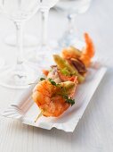 A prawn skewer with asparagus and thyme