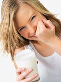 Woman holding glass of milk