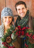 Couple holding christmas wreath