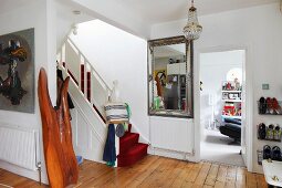 Red carpet on staircase in traditional foyer with wooden floor