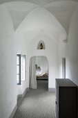 View from hallway into bedroom in former monastery; figure of Madonna in niche