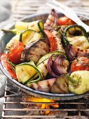 Assorted barbecued vegetables in a tray on the barbecue