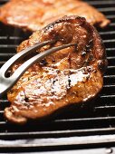 Barbecued pork steak on the barbecue