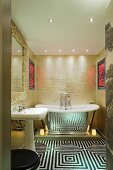 Extravagant bathroom with op art floor in front of mirrored, vintage bathtub