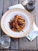 Penne with lamb sauce, tomatoes and rosemary