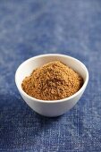 A small bowl of ground cumin