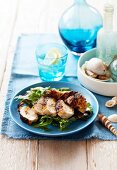 Marinated chicken breast, grilled, on a bed of green salad