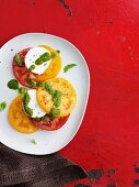 Red and yellow tomatoes with mozzarella and pesto