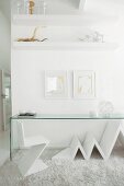 White, designer chair and minimalist glass table on flokati rug in front of partition in designer interior