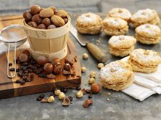 Coffee and hazelnut whoopie pies with icing sugar, nuts and coffee beans