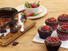 Chilli and chocolate cupcakes topped with plain chocolate and fresh chilli peppers