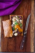 Puff pastry slice filled with vegetables, mushrooms and feta, with yellow tomato sauce