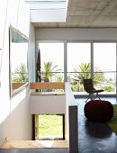 Head of staircase in open-plan interior with sliding glass wall