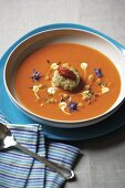 Smoked cream of pepper soup with fish purée and edible flowers
