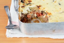 Moussaka in a casserole dish (section)