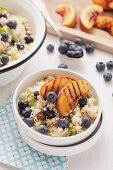 Blueberry and couscous salad with grilled peach wedges