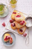 Madeleines with raspberries and limes