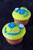 Lemon cupcakes topped with colourful fondant icing