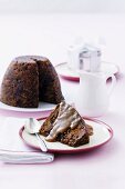 Figgy pudding with butterscotch sauce, one slice removed