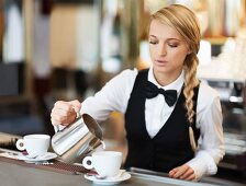 A waitress pouring coffee in a restaurant