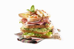 A sandwich stack (toast with cucumber, cured ham and cheese)