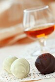 Two White Chocolate and a Chocolate Cinnamon Truffle; Snifter of Scotch