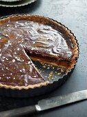 Chocolate torte in a baking tin, one slice removed