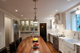 Walnut kitchen island in spacious country-house kitchen