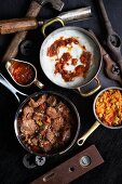 Beer-braised beef with pap (corn hash) and chakalaka relish (South Africa)