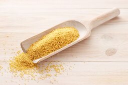 Millet on a wooden scoop