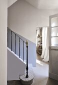 Wrought iron staircase balustrade in simple foyer of house