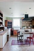 Country-house kitchen with dining table and chairs in various styles