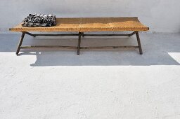 Black and white towel on a simple, North African lounger in a courtyard