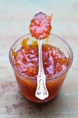 Grapefruit marmalade in a jar with a spoon